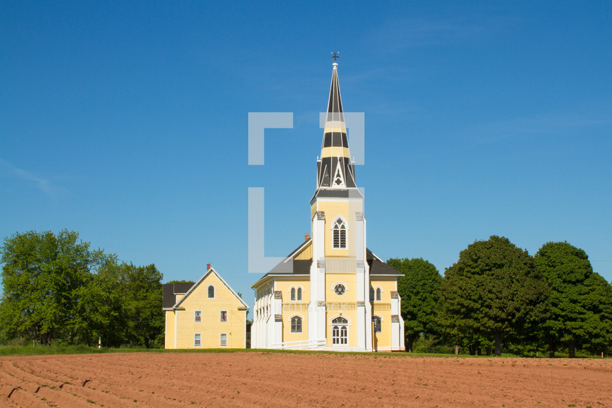plowed field and church 