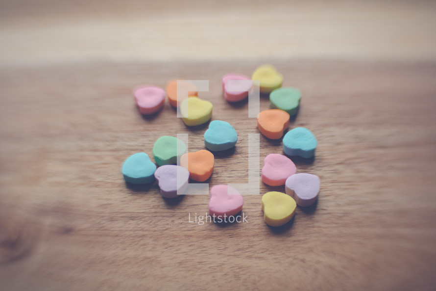 heart shaped candy on wood 