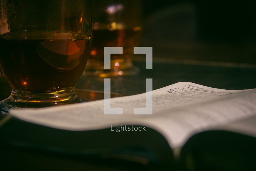 glass mug and open Bible 