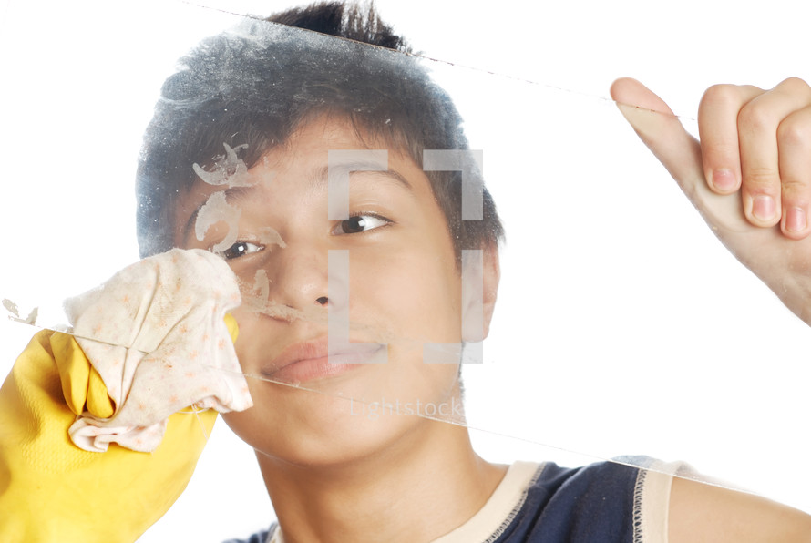 Young housecleaner in protective glove washing the glass