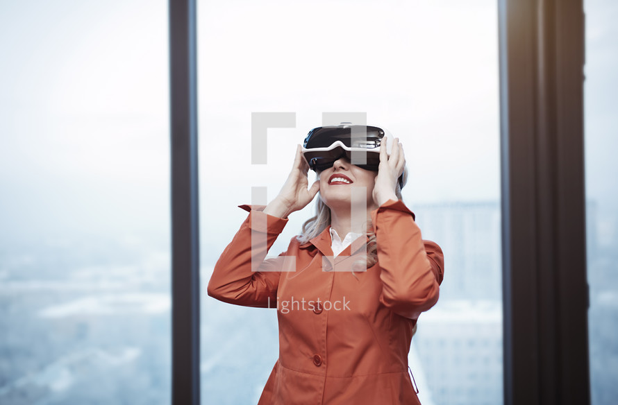 a woman in VR glasses looking up 
