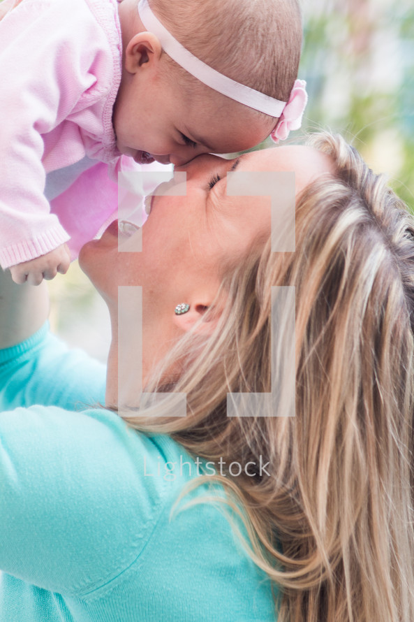 Mother and infant daughter laughing together.