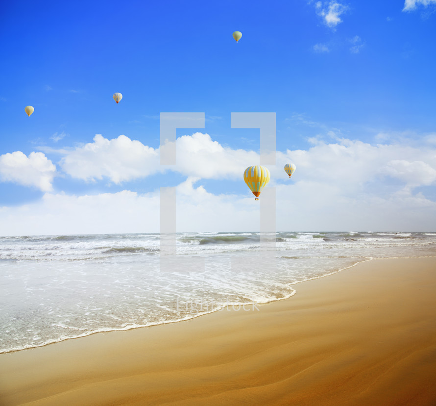 hot air balloons over a beach 