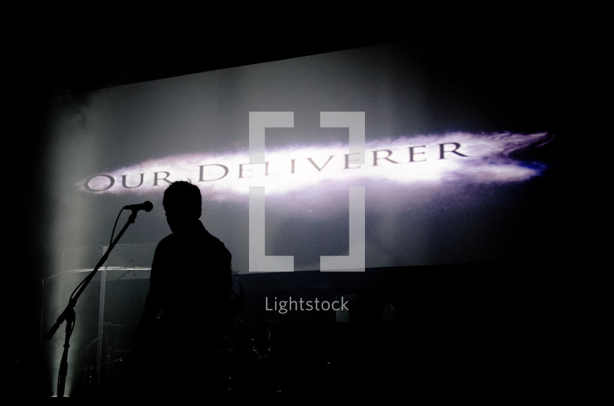 silhouette of a man on stage - our deliverer 