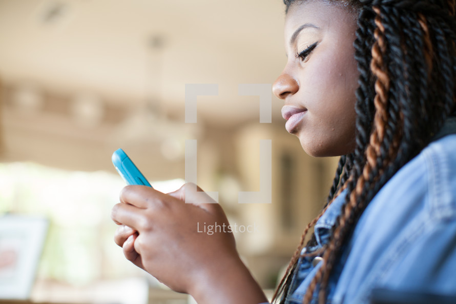 african-american woman texting on cellphone 