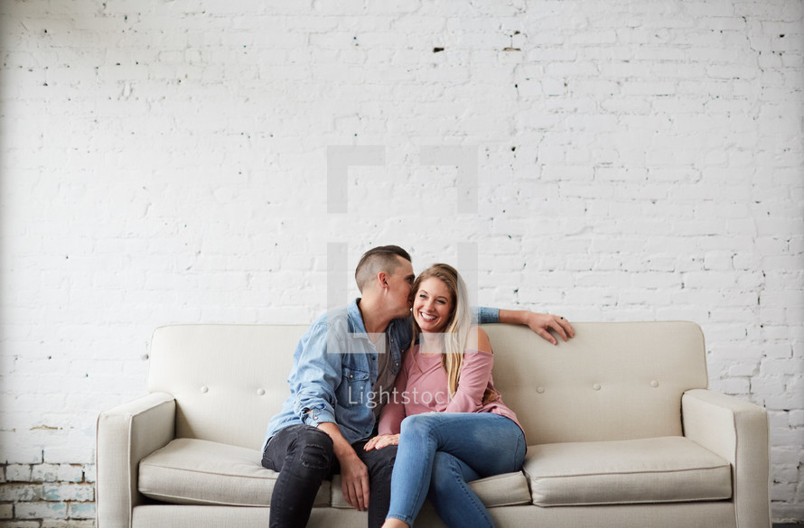a couple sitting on a couch talking 