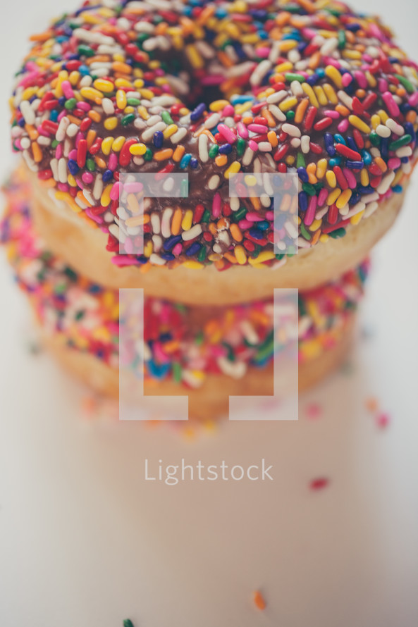 sprinkled donuts on a white background 