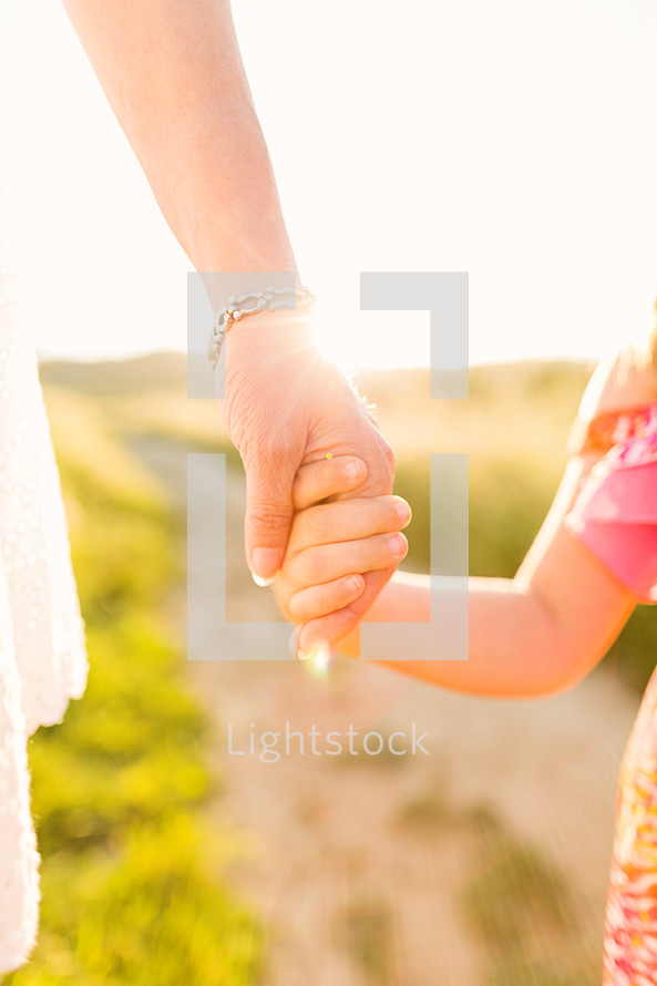 mother and daughter holding hands, leadership, growth, jesus hand