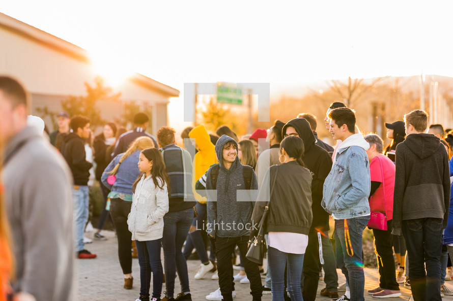 crowds of teens standing outdoors 