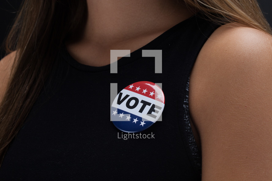 young woman with a vote pin 