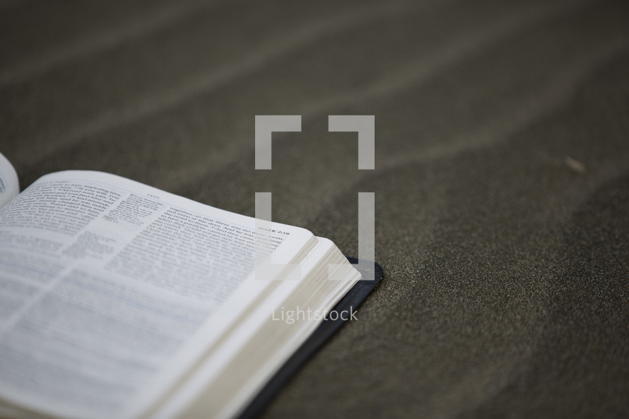 open Bible on sand 