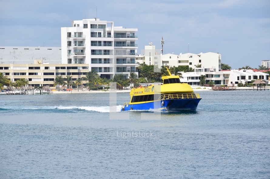 a ferry leaving the shores of Cancun 
