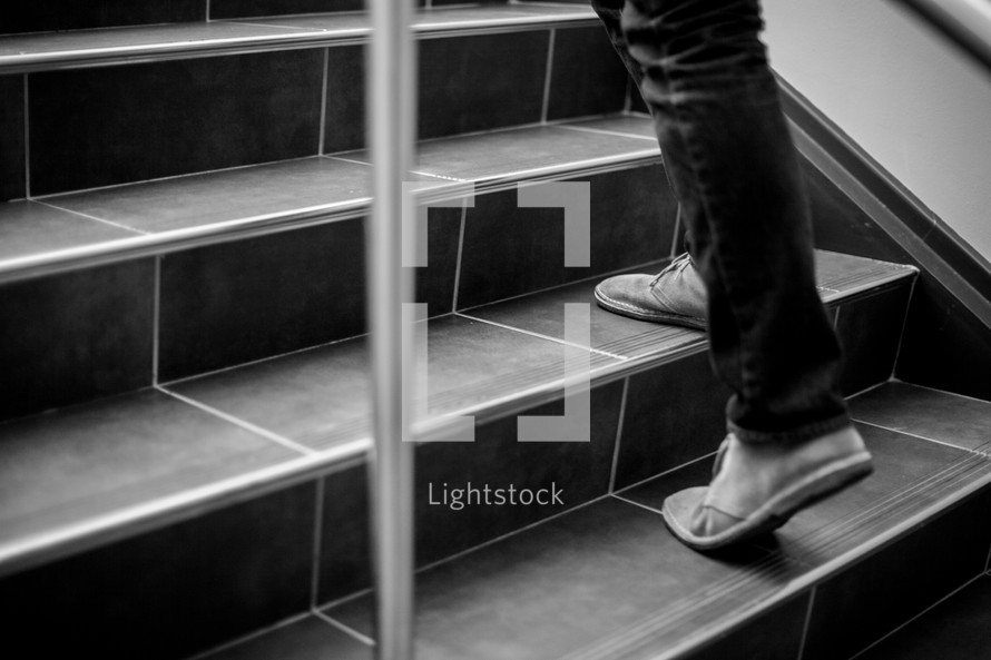 woman's feet walking up stairs