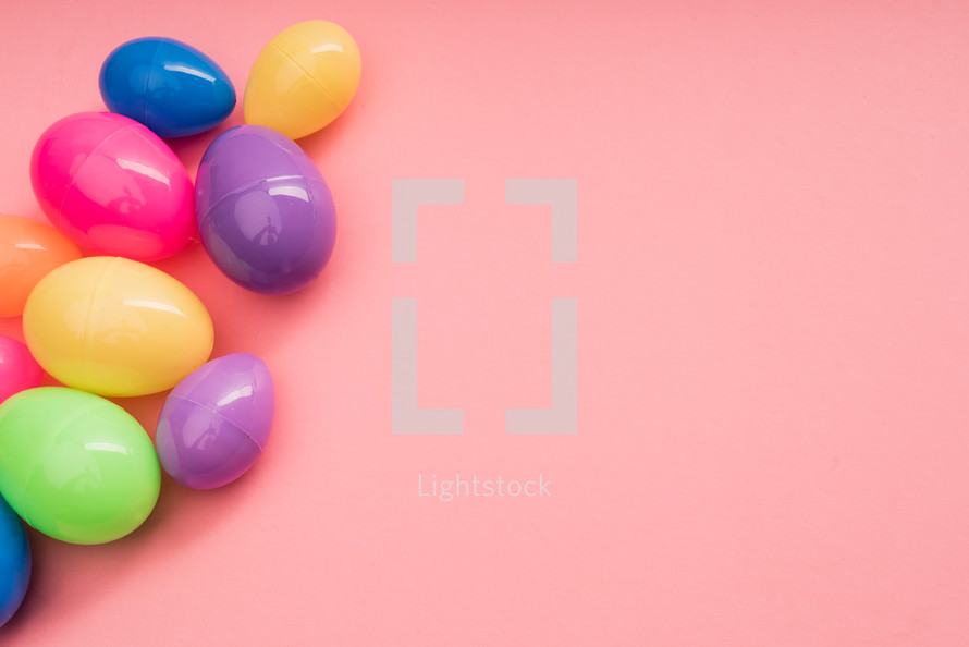 plastic Easter eggs on a pink background 