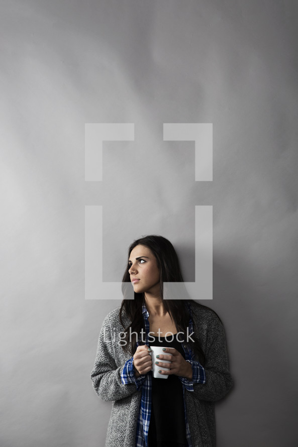 a woman holding a mug of coffee 