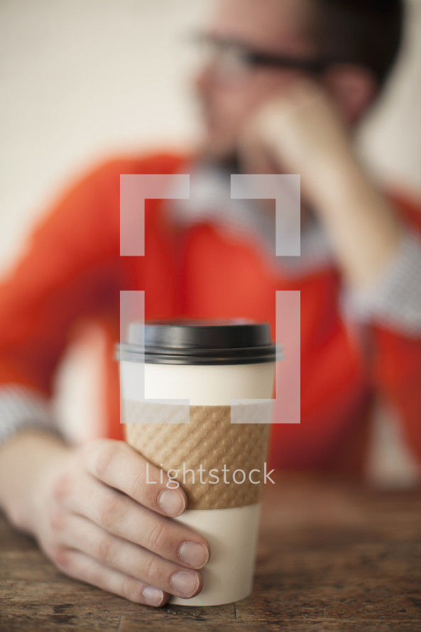 A man holding a coffee cup 