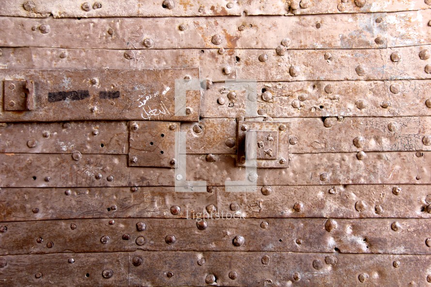 Plank wall with rivets.