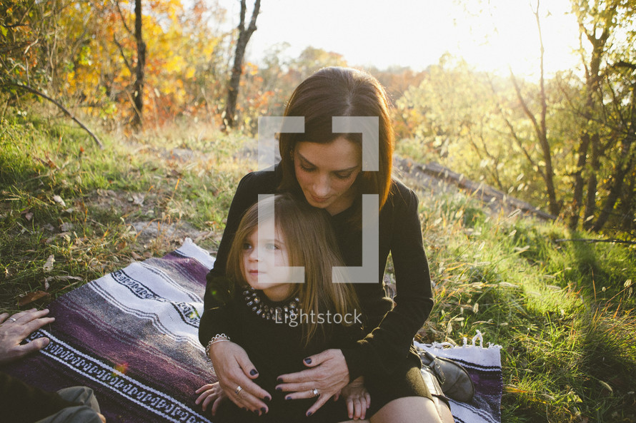 girl sitting on her mother's lap
