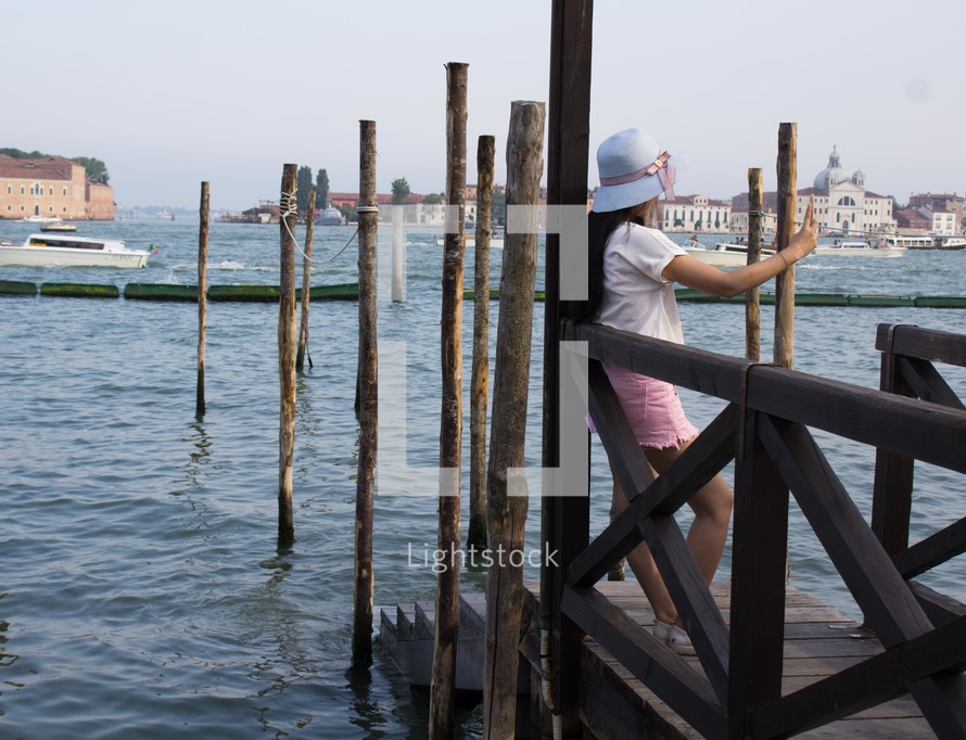 a woman taking a selfie on a dock in Venice 