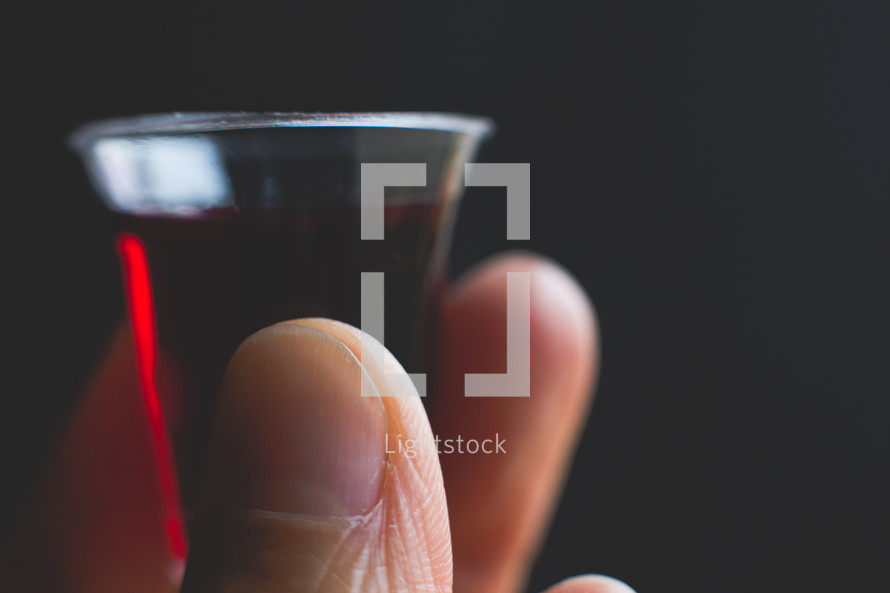 communion wine cup in hand