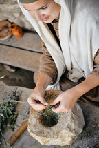a woman grinding herbs 