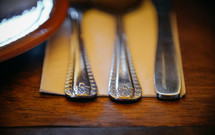 silver utensils on a napkin 
