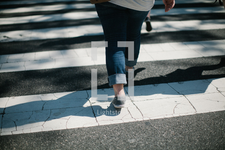 woman crossing a crosswalk 