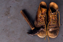 a hammer and old leather boots 