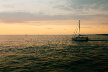 a sailboat on the water at sunset in Kona 