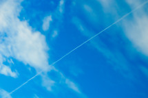 plane contrail in a blue sky 
