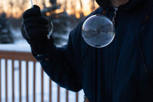 blowing bubbles outdoors in winter 