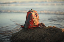 backpack on a rock on a beach 