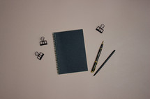 Notebook with pens and clips