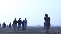 tribesmen walking in a desert 