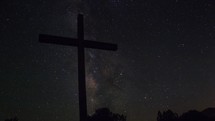 Time lapse of Milky Way stars moving behind a cross