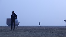 truck and men walking in desert 