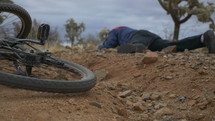 A man gets up after a wipe out on his mountain bike