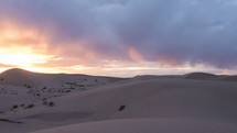 Timelapse of the setting sun over sand dunes