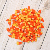 candy corn on wood background 