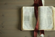 an open Bible on a coffee table