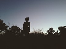 silhouette of a woman standing outdoors 