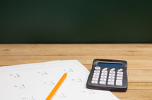 math worksheet and calculator on a desk 