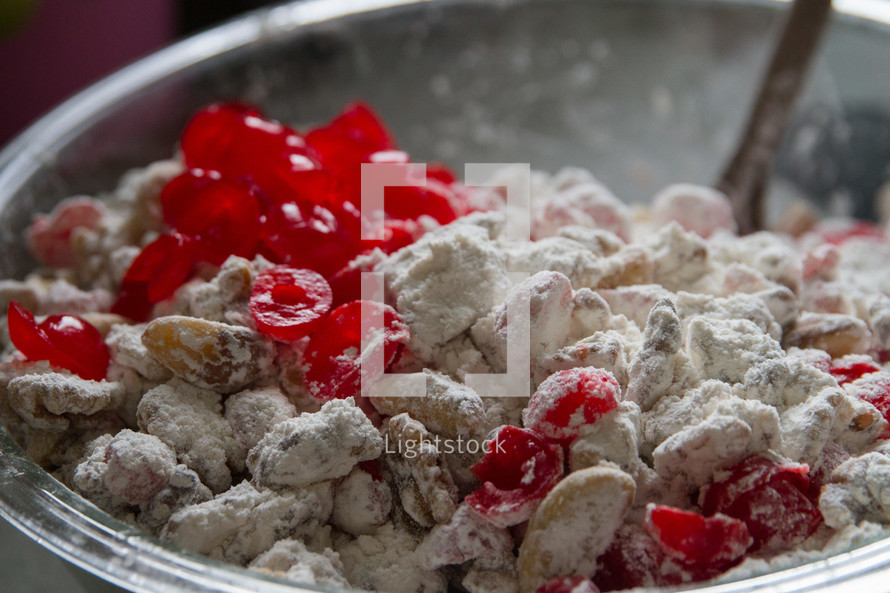 sticking cranberries and powdered sugar in a bowl 