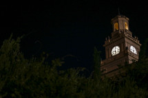 glowing clock tower at night 