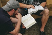 Two men sitting and studying the Bible together.
