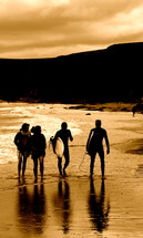 Surfer and friends walking on the beach