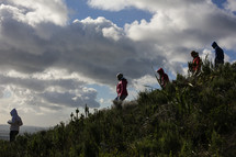 Group hiking down a hill