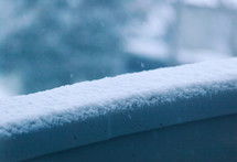 snow on a railing 