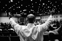 Outstretched hands during a worship service.