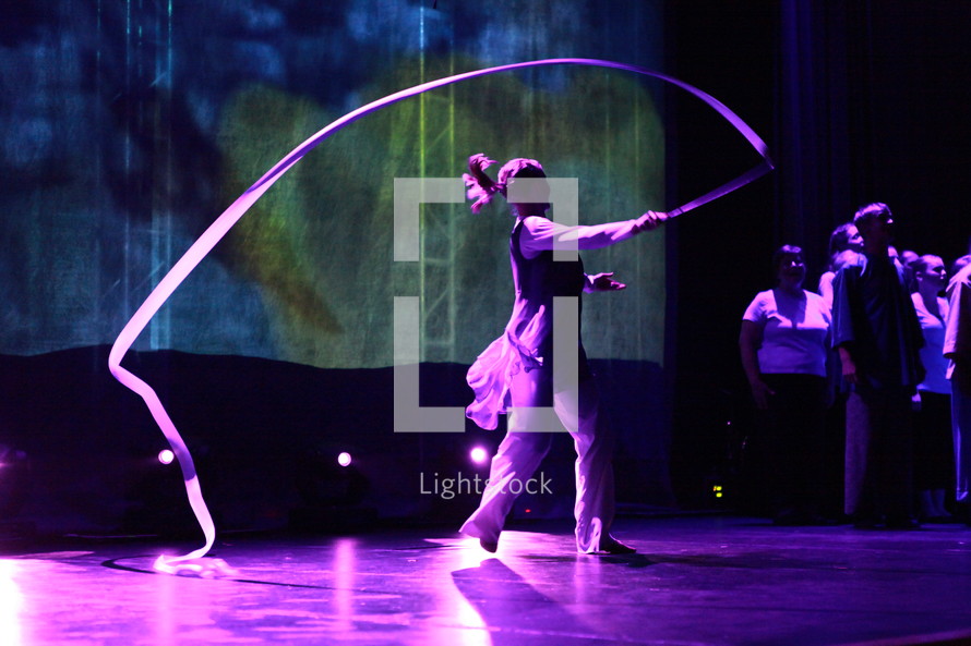 performer ribbon twirling on stage